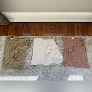 3 sarongs. From right to left: Elif. Robin Piccone. Camila Coelho.